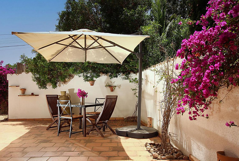 Terrasse mit Sonnenschirm und Gartenmöbeln