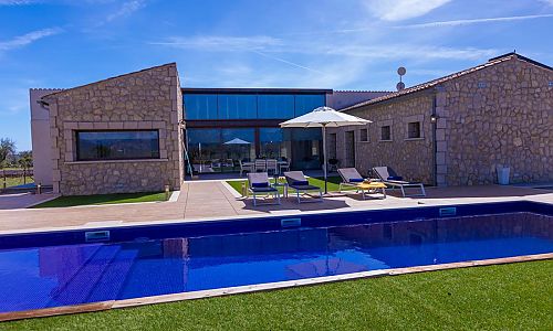 Poolterrasse mit Rasen vor der Finca