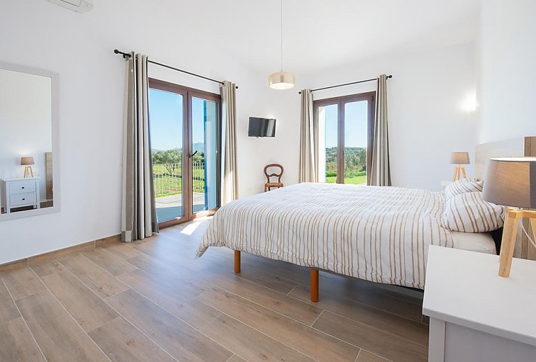 Schlafzimmer mit Doppelbett und Spiegel