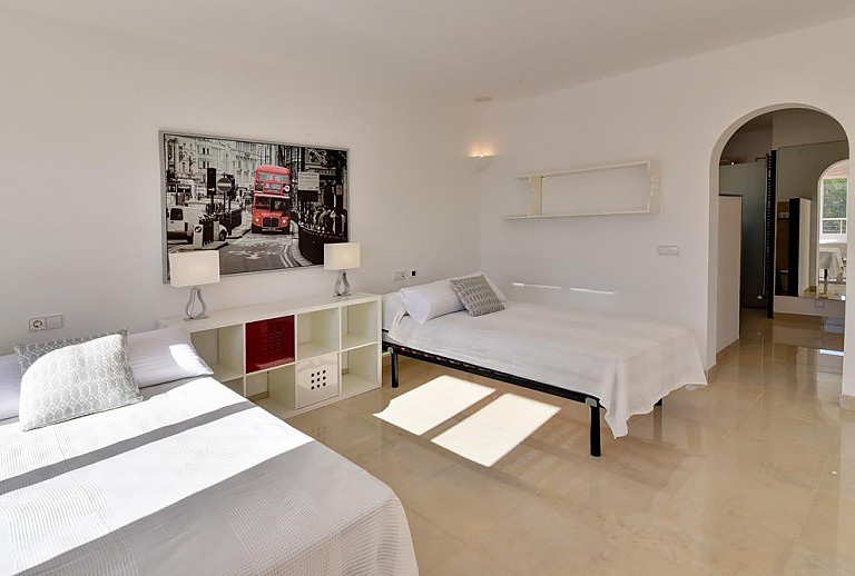 Schlafzimmer mit Einzelbetten und Regalen