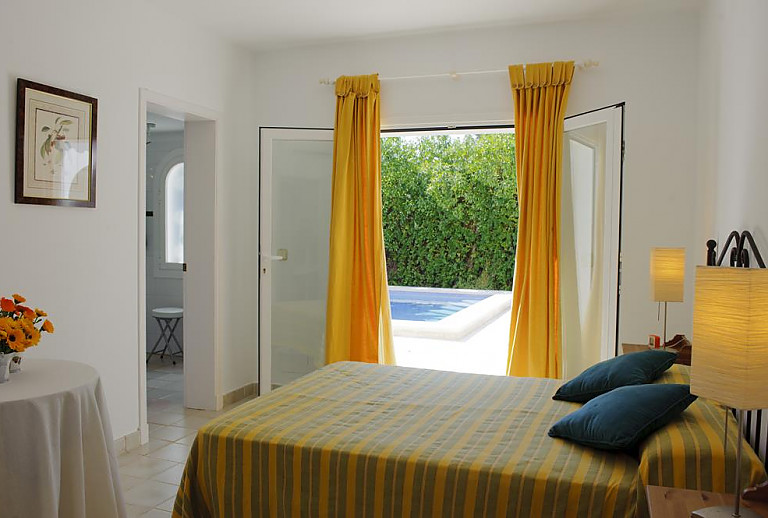 Schlafzimmer mit Doppelbett und Terrassentür