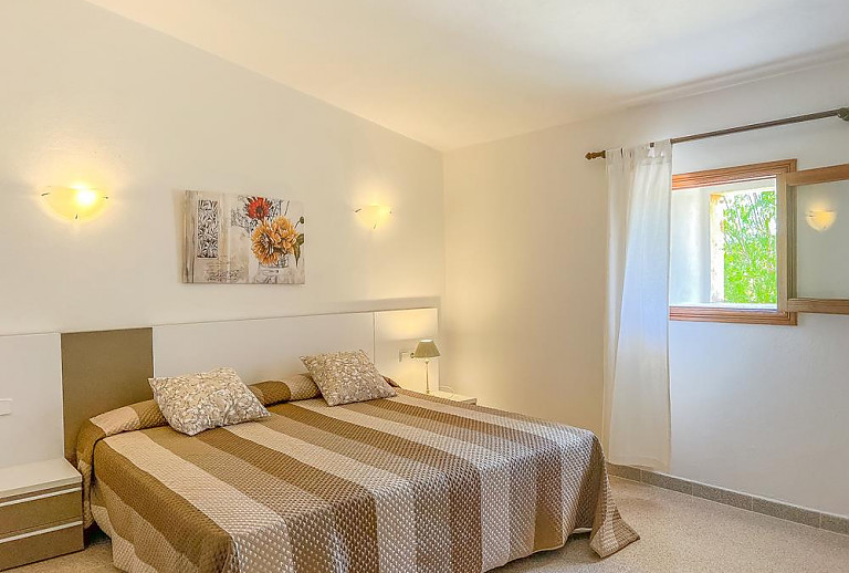 Schlafzimmer mit Doppelbett und Fenster