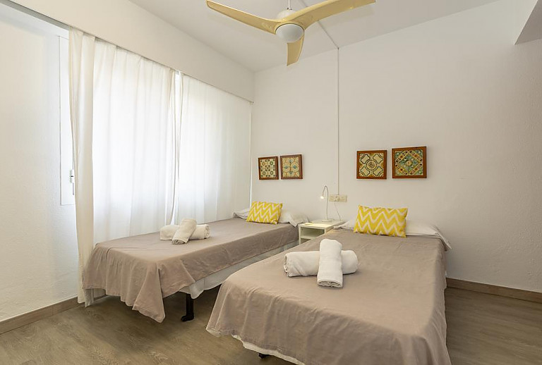 Schlafzimmer mit Einzelbetten und Wandbildern