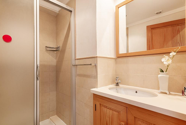 Schlafzimmer mit Dusche und Waschbecken