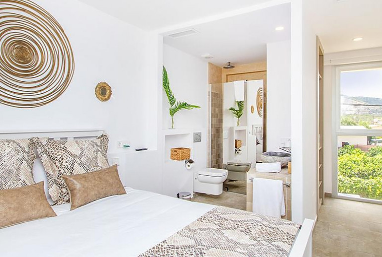 Schlafzimmer mit Doppelbett und Badezimmer