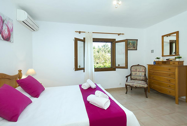 Schlafzimmer mit Doppelbett und Kommode