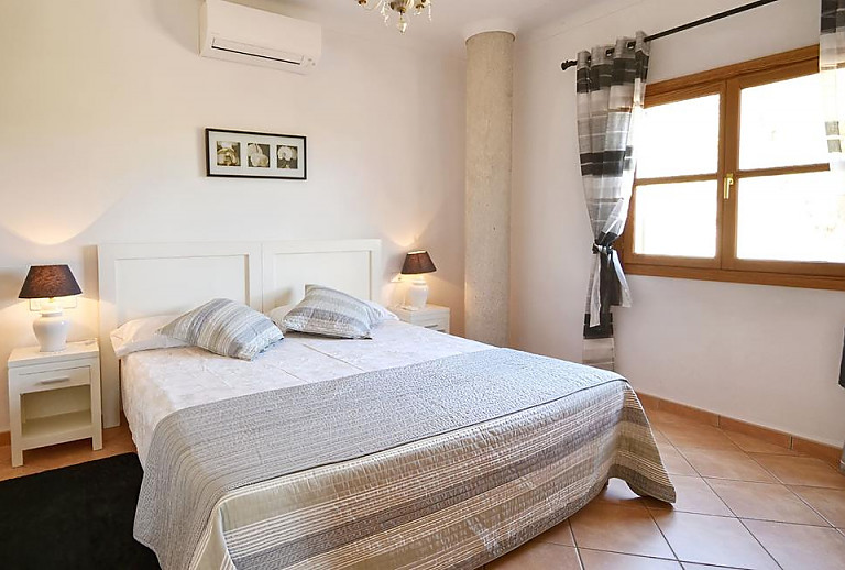 Schlafzimmer mit Doppelbett und Nachttisch