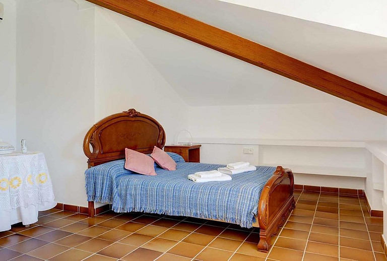 Schlafzimmer mit Doppelbett und Nachttisch