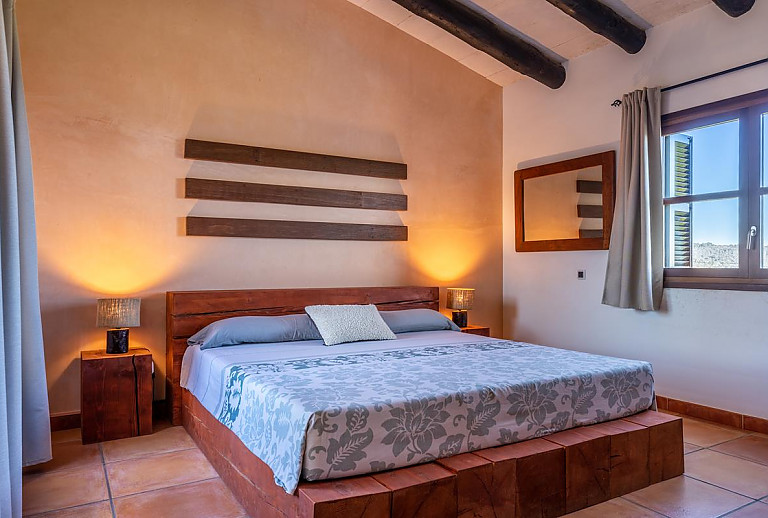 Schlafzimmer mit Doppelbett und Spiegel