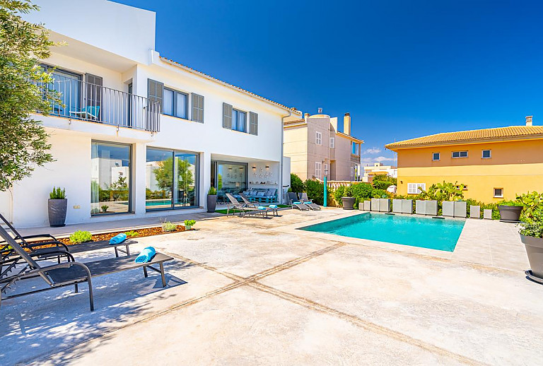 Poolterrasse vor dem Ferienhaus mit Sonnenliegen 