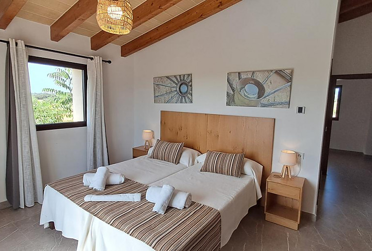 Schlafzimmer mit Einzelbetten und Wandbildern